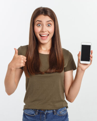 Girl Holding Smart Phone - Beautiful smiling girl holding a smart phone.